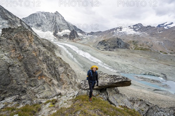 Mountaineer at Col de Riedmatten, view of glacier Glacier de Cheilon and mountain peak Mont Blanc de Cheilon, Valais, Western Alps Switzerland