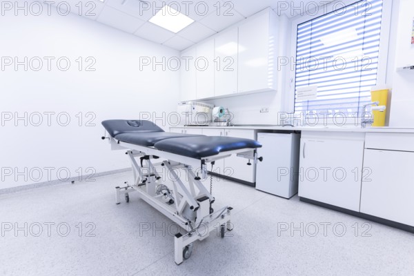 Modern clinic room with examination couch and window, bright and sterile, Urology, Germany, Europe