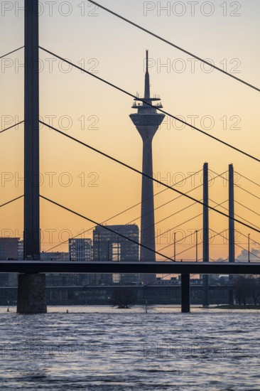 Sunset on the Rhine near Düsseldorf, skyline of the city centre with Rhine Tower, Rheinkniebrücke, behind, Oberkassler Brücke, North Rhine-Westphalia, Germany, Europe