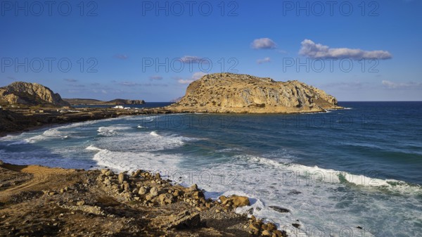 Rocky coastal landscape with blue sky and crashing waves, Acropolis Hill, Arkasa, West Coast, Karpathos, Dodecanese, Greek Islands, Greece, Europe