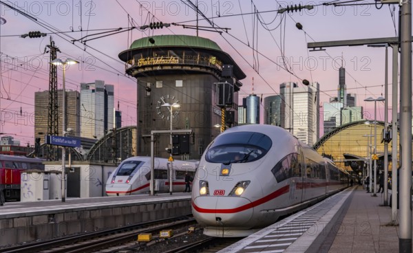 Frankfurt main station with ICE in the evening, sunset. View of platform and banking district, skyline of Frankfurt am Main, Hesse, Germany, Europe