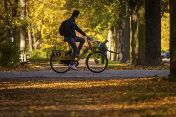 The Great Garden in Dresden is a park of Baroque origin. In the course of its more than three hundred years of history, the Great Garden has been remodelled many times, although the basic baroque structure has remained recognisable. Cyclists and gardeners blowing leaves, Dresden, Saxony, Germany, Europe