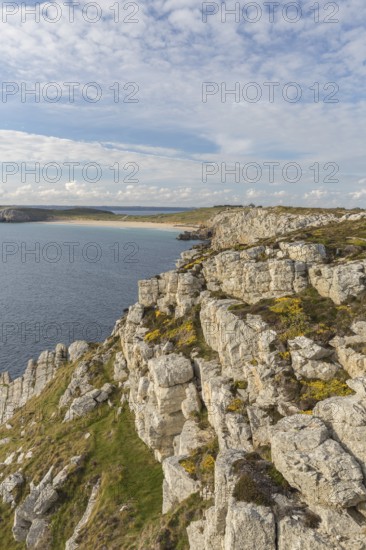 Rocky coast of Camaret-sur-Mer in the Finistère department in northwestern France, with a partly cloudy sky