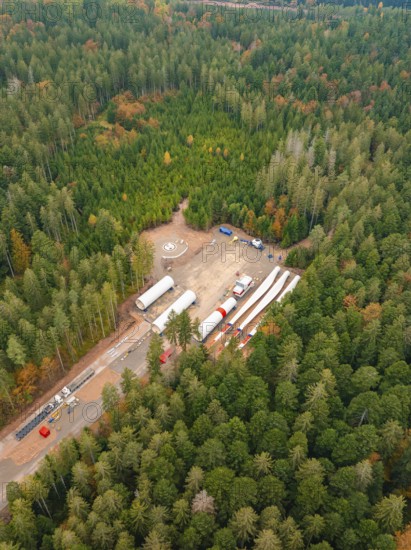 Construction site in the forest with wind power components surrounded by colourful autumn leaves, aerial view, wind farm construction site, Grömbach, Black Forest, Germany, Europe