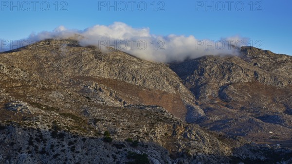 Mountain landscape with clouds floating on the peaks, under a blue sky, Morning mountain landscape, Lastos, Island centre, Karpathos, Dodecanese, Greek Islands, Greece, Europe