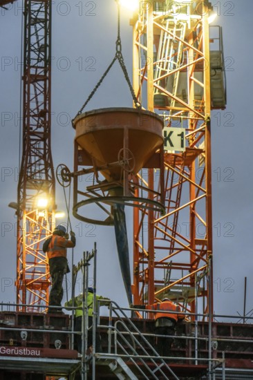 Concrete work, at dusk, on a large construction site building a residential and commercial complex, North Rhine-Westphalia, Germany, Europe