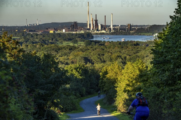 View, from the Rheinpreußen spoil tip in Mörs, across the Rhine to the Thyssenkrupp Steel steelworks in Duisburg-Beeckerwerth, blast furnaces, coking plant, green landscape on the left bank of the Rhine, North Rhine-Westphalia, Germany, Europe