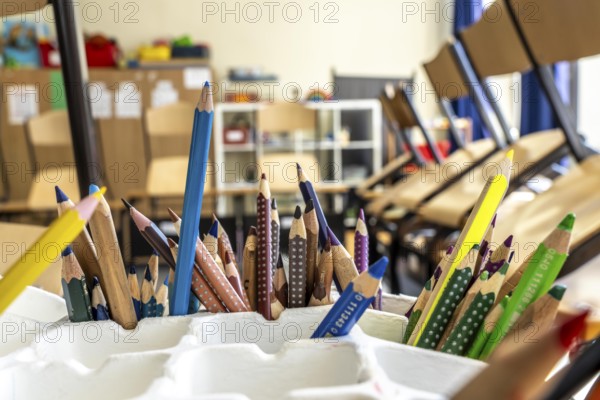 Classroom of a fourth grade, after school, the building is older but in good condition, coloured pencils