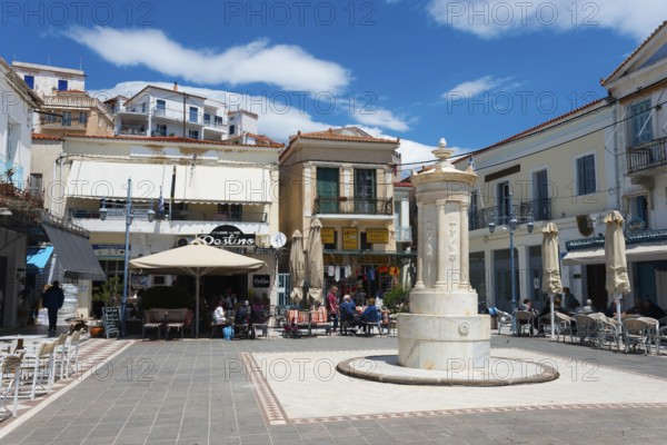 Lively square with a central fountain, surrounded by cafés and historic buildings, Old Fountain, Karamanou Square, Poros, Poros Island, Saronic Islands, Peloponnese, Greece, Europe