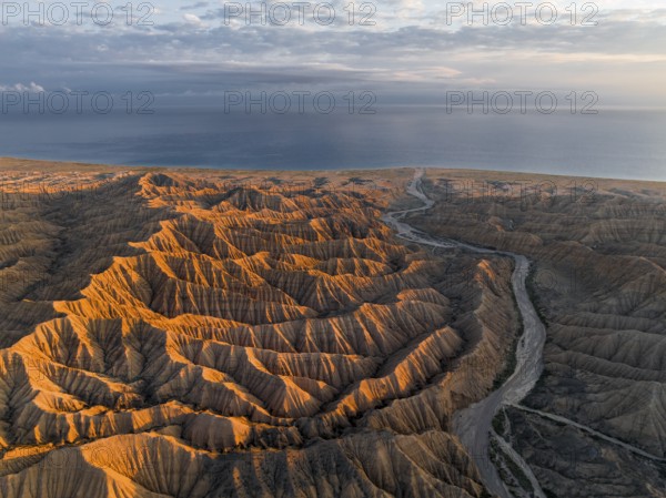 Landscape of eroded hills at Lake Issyk Kul, Badlands at sunrise, aerial view, Canyon of the Forgotten Rivers, Issyk Kul, Kyrgyzstan, Asia