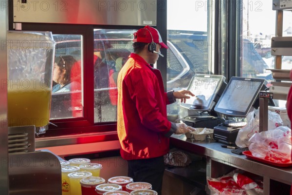 Sterling Heights, Michigan, Workers serve up Chickenjoy fried chicken at Jollibee, a Filipino fast food chain. Jollibee is called the McDonald's of the Philippines. It has 1400 stores worldwide. This one is the first location in Michigan. The chain focuses on locations with many Filipino-Americans