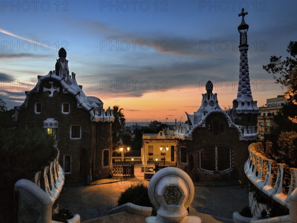 Building with mosaics, Park Güell entrance at dawn, in front of sunrise, Barcelona, Spain, Europe