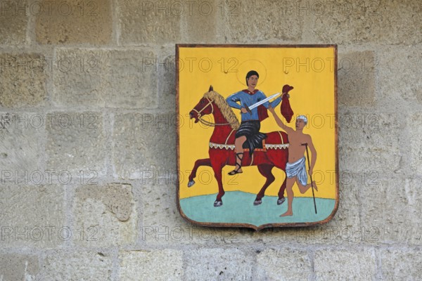 City coat of arms at the Porte de la Gardette, city gate, detail, Saint Martin, saint, horse figure, beggar, share, give, take, care, charity, Christian, Aigues-Mortes, Gard, Camargue, Provence, France, Europe