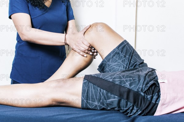 Physiotherapist woman checking patient's leg. Orthopedic specialist helping a patient with a leg injury. Leg rehabilitation physiotherapy. physiotherapy treatment concept