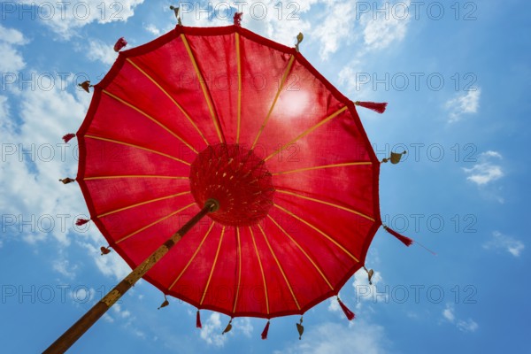 Traditional Balinese temple sunshade as parasol, Hinduism, symbol, beach holiday, protection, sun protection, Balinese, culture, red, yellow, sun, relaxation, relax, blue sky, cliché, holiday cliché, holiday feeling, holiday mood, spa, relax, chill out, shade, shade dispenser, decorated, summer, long-distance travel, exotic, holiday idyll, paradisiacal, water, sea, ocean, coast, travel, holiday, tourism, sea view, Asian, Bali, Indonesia, Asia