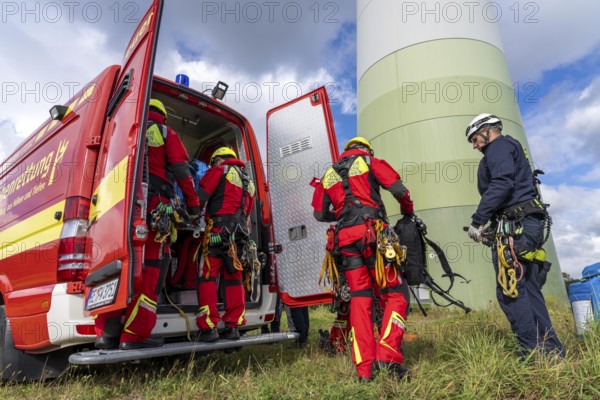 Height rescuers from the Gelsenkirchen fire brigade practise abseiling from a wind turbine from a height of 110 metres after rescuing an accident victim from the nacelle, Gladbeck, North Rhine-Westphalia, Germany, Europe