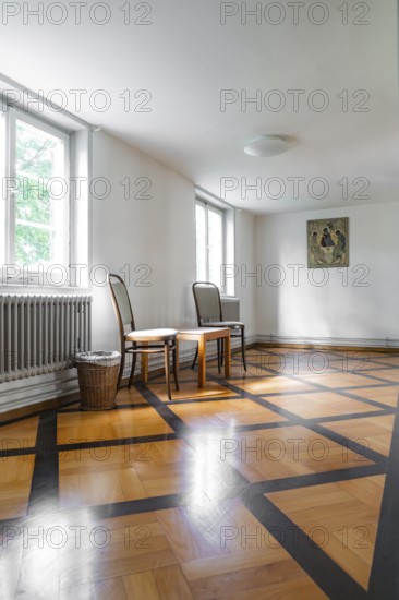 Bright room corner with artwork on the wall, chairs and wooden floor, Kirchheim Teck, Germany, Europe