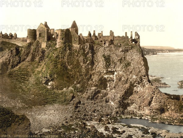 Dunluce Castle, one of the largest ruins of a medieval castle in Ireland. It is located on a basalt rock on the rugged north coast of the island, between the villages of Portballintrae and Portrush in County Antrim in Northern Ireland, Historic, digitally restored reproduction from a 19th century original, Record date not stated