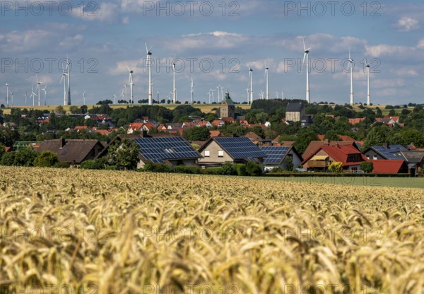 Wind farm near the East Westphalian town of Energiestadt Lichtenau, many residential buildings with photovoltaic systems on the roofs, over 80 wind turbines on this hill, in total there are more than 200 wind turbines around the town, producing 9 times more electricity than the town itself consumes, the rest is fed into the grid, North Rhine-Westphalia, Germany, Europe