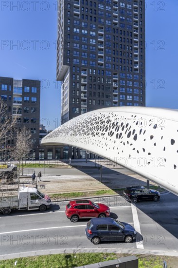 The Parkbruk, cycle and pedestrian bridge in the city centre of Antwerp, crosses a multi-lane city centre road, with tram lines, and thus connects two lively city districts Kop Spoor Noord and Eilandje, light effects by the sun, on the roadway, Belgium, Europe