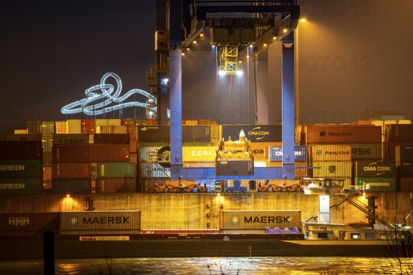 Container Handling Centre, Gateway West Terminal, Logport 2, cargo ship, in Duisburg on the Rhine, in the background Tiger and Turtle - Magic Mountain is a landmark modelled on a roller coaster on Heinrich-Hildebrand-Höhe in Angerpark in Duisburg-Angerhausen, North Rhine-Westphalia, Germany, Europe