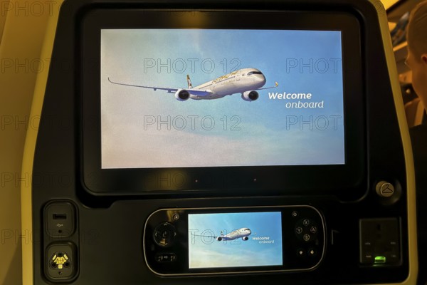 Aircraft of the airline Etihad, interior with monitor for the passenger with the text welcome onboard. Boeing 787 aircraft, Abu Dhabi, United Arab Emirates, UAE, Asia