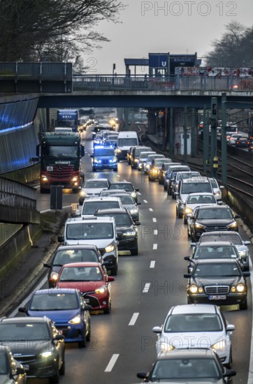 Traffic jam on the A40 motorway, emergency lane, vehicles on the left and right, police patrol car with flashing blue lights and siren, Essen, North Rhine-Westphalia, Germany, Europe