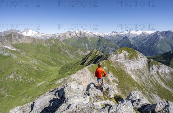 Mountaineer in front of mountain panorama with Großvenediger, mountain landscape with mountain peaks of the Venediger group, view from the summit of the Gösleswand, Lasörling group, Hohe Tauern National Park, East Tyrol, Tyrol, Austria, Europe