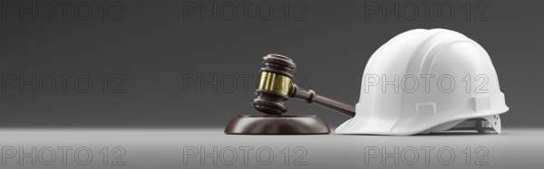 White hard hat and gavel on a gradated background banner with room for text or graphics