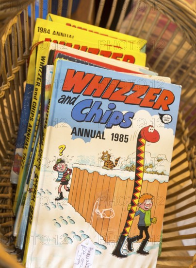 1980s children's cartoon comic book annuals Whizzer and Chips 1985, inside antiques centre, Marlesford Mill, Suffolk, England, UK