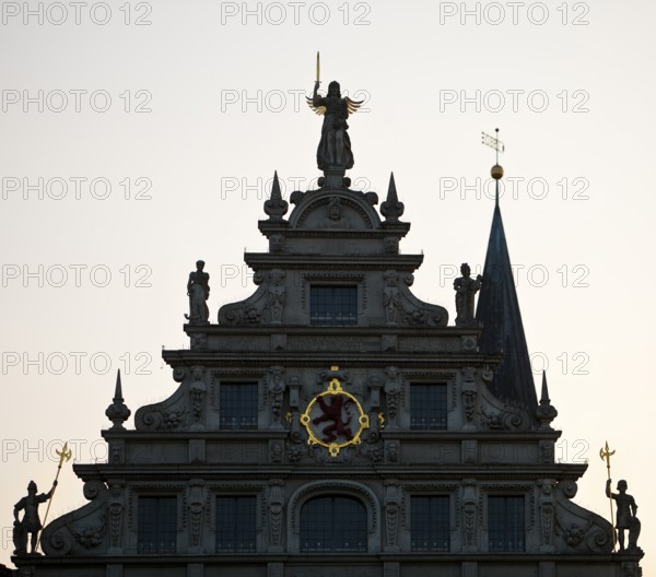 Gewandhaus with Brunswick lion and a church tower of St Martini against the light, Old Town, Brunswick, Lower Saxony, Germany, Europe