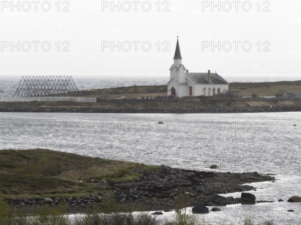 Nesseby town church, with congregation standing outside on Whit Sunday, May, Varanger Fjord, Norway, Europe