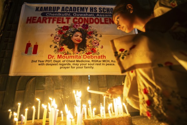 Students light candles as they pay tribute to a victim of rape and murder of a doctor inside a hospital in Kolkata, on August 18, 2024 in Guwahati, India. A trainee doctor, 31, was attacked at RG Kar Medical College and Hospital in Kolkata, the capital of West Bengal, last week