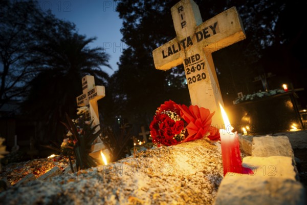 People from Christian community light candles and offer prayers on the grave of their relative during the All souls day observation, in Guwahati, India on 2 November 2024. All Souls' Day is a Christian holiday dedicated to honoring and praying for the souls of the departed