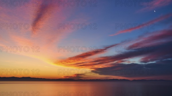 Colourful sky with crescent moon at sunrise over the sea, Mani Peninsula, Peloponnese, Greece, Europe