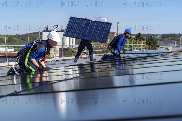 Installation of solar modules on the roof of a commercial enterprise, over 400 photovoltaic modules are installed on the roof, North Rhine-Westphalia, Germany, Europe