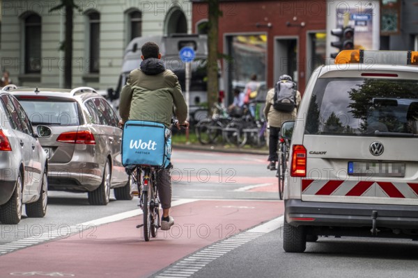 Bicycle lane, marked red, between 2 lanes for vehicles, city centre traffic, Dortmund, North Rhine-Westphalia, Germany, Europe