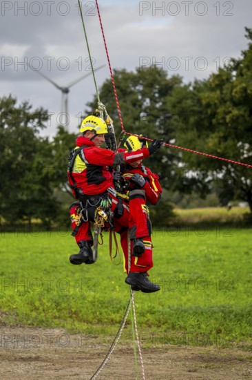 Height rescuers from the Gelsenkirchen fire brigade practise abseiling from a wind turbine from a height of 110 metres after rescuing an accident victim from the nacelle, Gladbeck, North Rhine-Westphalia, Germany, Europe