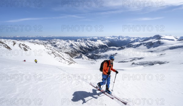 Ski tourers in front of a mountain panorama, snow-covered mountain landscape with glacier in winter, view into Val Venezia, high tour, ascent to Monte Cevedale, Ortler Alps, Vinschgau Valley, Italy, Europe