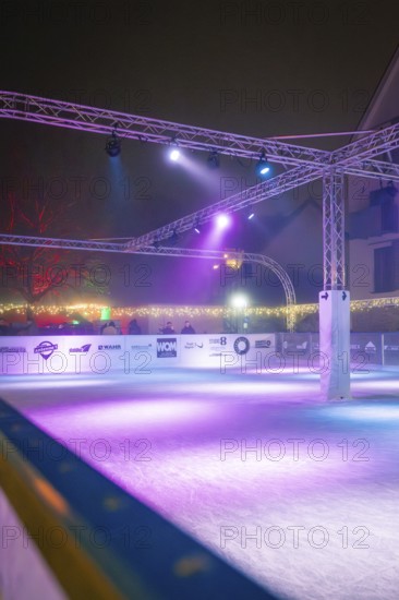 Vacant ice rink in a night-time atmosphere with purple lighting and modern architecture, Christmas market, Nagold, Black Forest, Germany, Europe