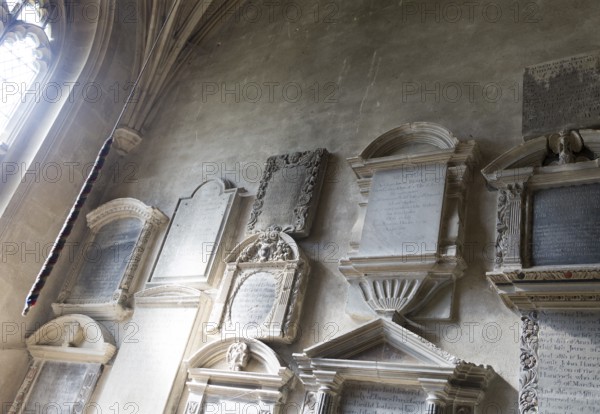 Wall mounted historic grave memorials Interior of church of Saint Bartholomew, Corsham, Wiltshire, England, UK