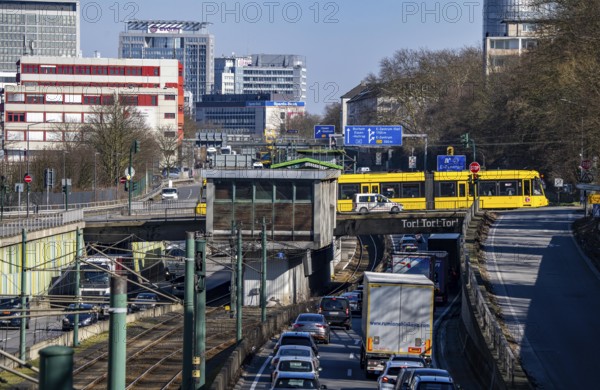 Motorway A40, Ruhr expressway, heavy traffic jam, rush hour, city passage in Essen, skyline of the city centre, underground line between the lanes, Hobeisenbrücke stop, North Rhine-Westphalia, Germany, Europe