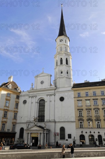 Baroque church with high tower on a lively square under a clear sky, Vienna, Austria, Europe