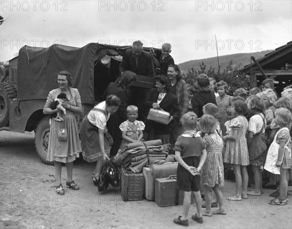 Belgian displaced persons load their luggage on a truck (Germany) June 9, 1945