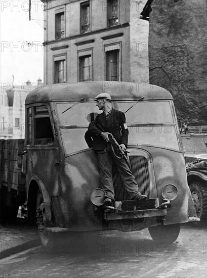 A French F.F.I. takes cover in Dreux (France) August 19, 1944