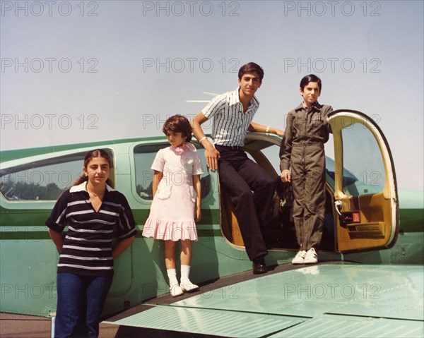 Ali Reza Pahlavi dressed up in pilote uniform, with his brothers and sisters