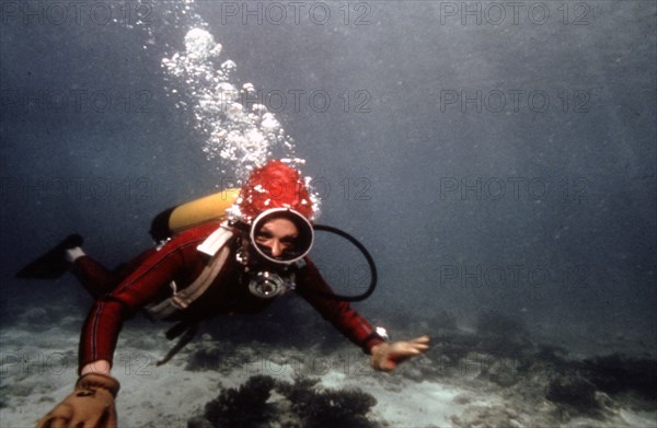 Farah Pahlavi diving during her holidays on Kish island, 1975