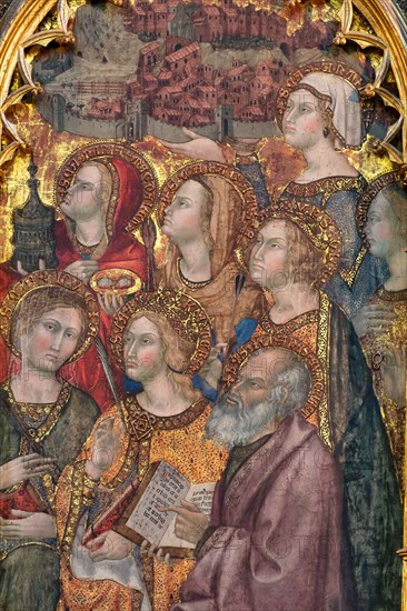 Montepulciano, Duomo (Cathedral of S. Maria Assunta), the interior, the main altar: the monumental "Triptych of the Assumption", painted by Taddeo di Bartolo in 1401. The central panel of the triptych shows the monumental figure of the Madonna Assunta surrounded by Angels, while below are visible the twelve apostles crowding around the empty tomb of the Madonna. Above the Assumption we see the Coronation of the Virgin. The three scenes must be read as a time sequence from bottom to top with the Death of the Virgin, her Assumption and her Coronation. The two side panels depict various Saints in the attitude of adoring the central figure of the Madonna, while on the four pillars that delimit the various panels we see twelve small figures of Doctors of the Church (three per pillar). Above the two side panels are the Announcing Angel (on the left) and the Madonna Annunziata (on the right). The predella at the bottom depicts Nine scenes from the life of Jesus Christ while above the predella...