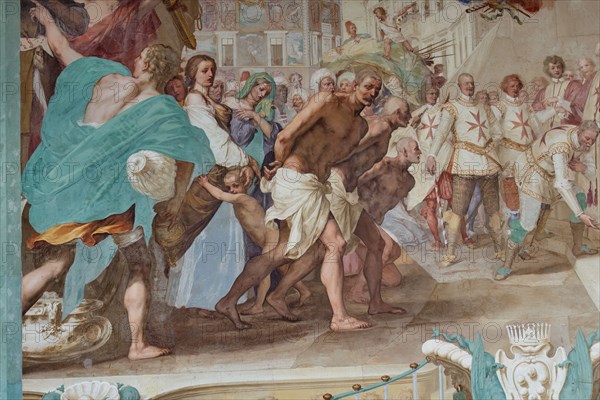 Medici Villa La Petraia, courtyard: “Cosimo II receives the winners of the Bona's feat”, fresco from the cycle of the Fasti Medicei by Volterrano (Baldassarre Franceschini), 1636-1647.
Against the background of Piazza dei Cavalieri in Pisa, Cosimo II, still heir to the throne, receives in the churchyard of the church of Santo Stefano dei Cavalieri the Tuscan nobles engaged in a victorious expedition in the battle of Bona, in Algeria, fought between the Genoese and the Turks on 16 September 1608. Among those present are Silvio Piccolomini, Admiral Jacopo Inghirami, the Marquis Fabrizio di Colloredo and other knights, who climbed into the depths. In the foreground we see the prisoners, who are advanced in front of the spoils of war. The chained and bare-chested slaves have their counterpart in the clothed and turbaned prisoners near the prince.
Detail.
Villa medicea La Petraia, Firenze (FI) - Florence, Toscana - Tuscany, Italia - Italy