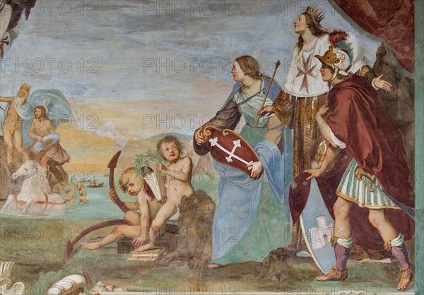 Medici Villa La Petraia, courtyard:“Dominance of Tuscany over the sea”, fresco from the cycle of the Fasti Medicei by Volterrano (Baldassarre Franceschini), 1636-1647.
The scene is set in Livorno, the Medici port and ideal city refounded by Francesco I de' Medici and his brother Ferdinand I, in the shadow of the monument of the Four Moors, with the statue of Ferdinand crowned by two winged victories. In the centre, in the background, Neptune's chariot proceeds, with Galatea and Perseus (holding Medusa's shield), to which the sea god points the statue. They sail among a large group of galleys of the Order of Saint Stephen.
On the right, in front of a cloth held up by putti in the face and under a personification of Fame, we see the allegories of Tuscany (with the crossed shield), of the Grand Duchy (with crown, scepter and mantle with the crest of the Order) and of Livorno, with the castle coat of arms.
Detail.
Villa medicea La Petraia, Firenze (FI) - Florence, Toscana - Tuscany, It...